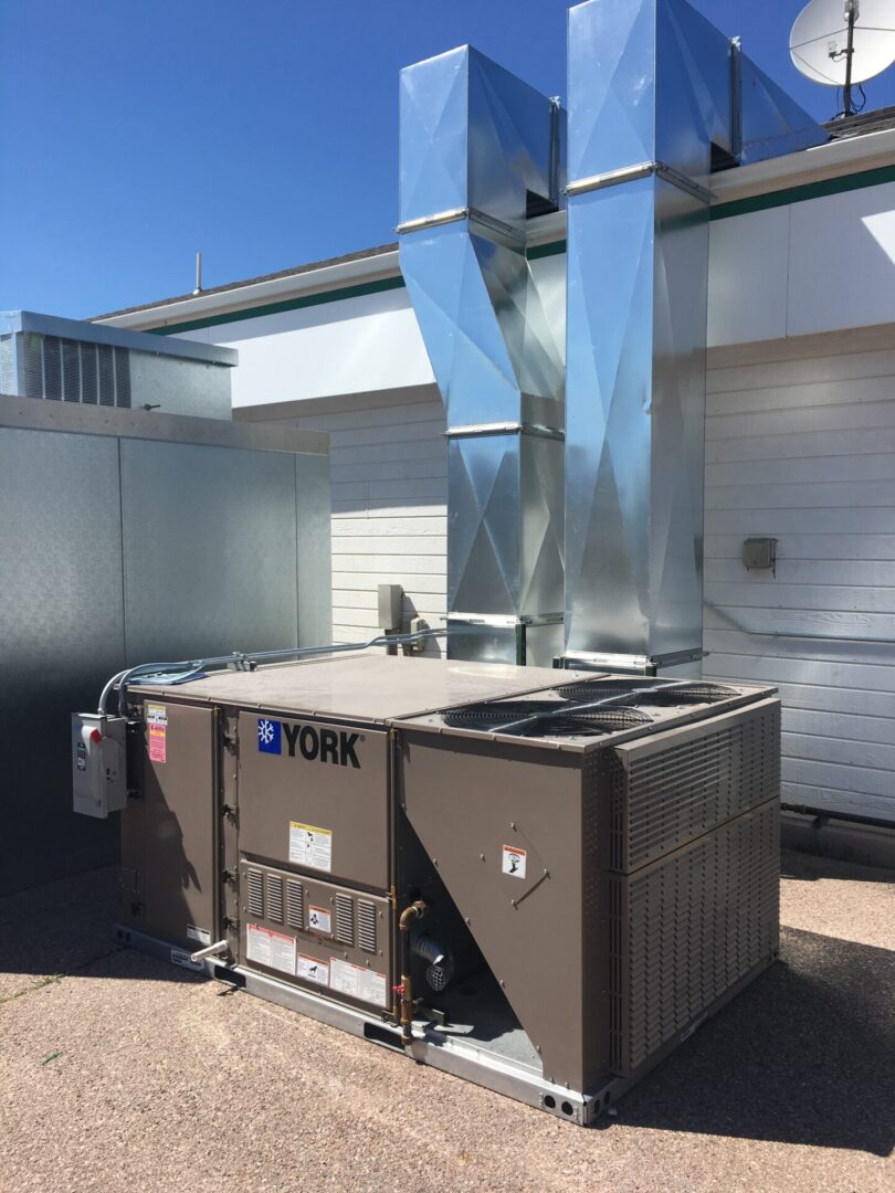 Rooftop York HVAC unit with metal ducts