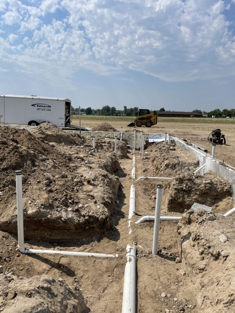 Exposed PVC plumbing in construction trenches