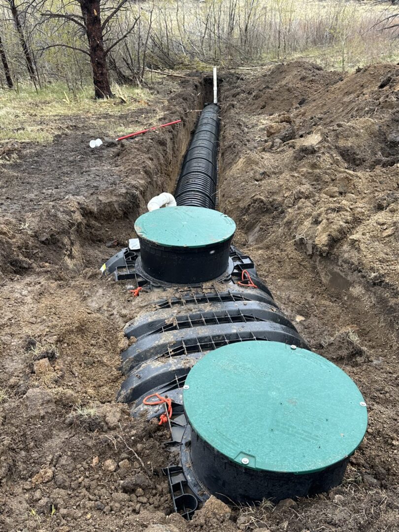 Underground septic tank with green access lids