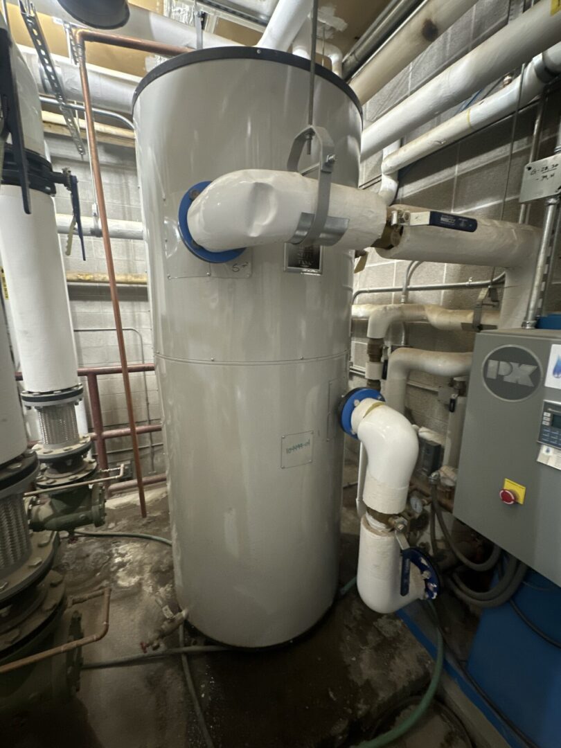 Vertical industrial water tank with piping