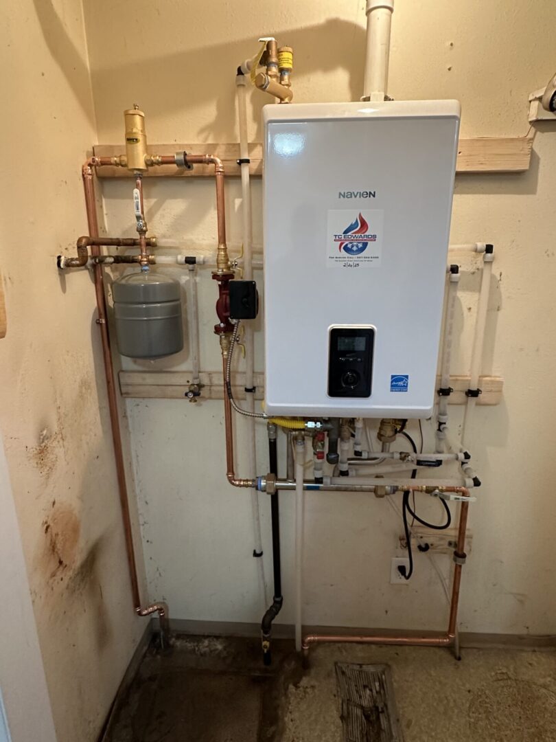 White tankless boiler with exposed copper pipes
