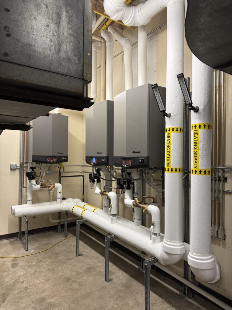 Mechanical room with commercial boilers and pipes
