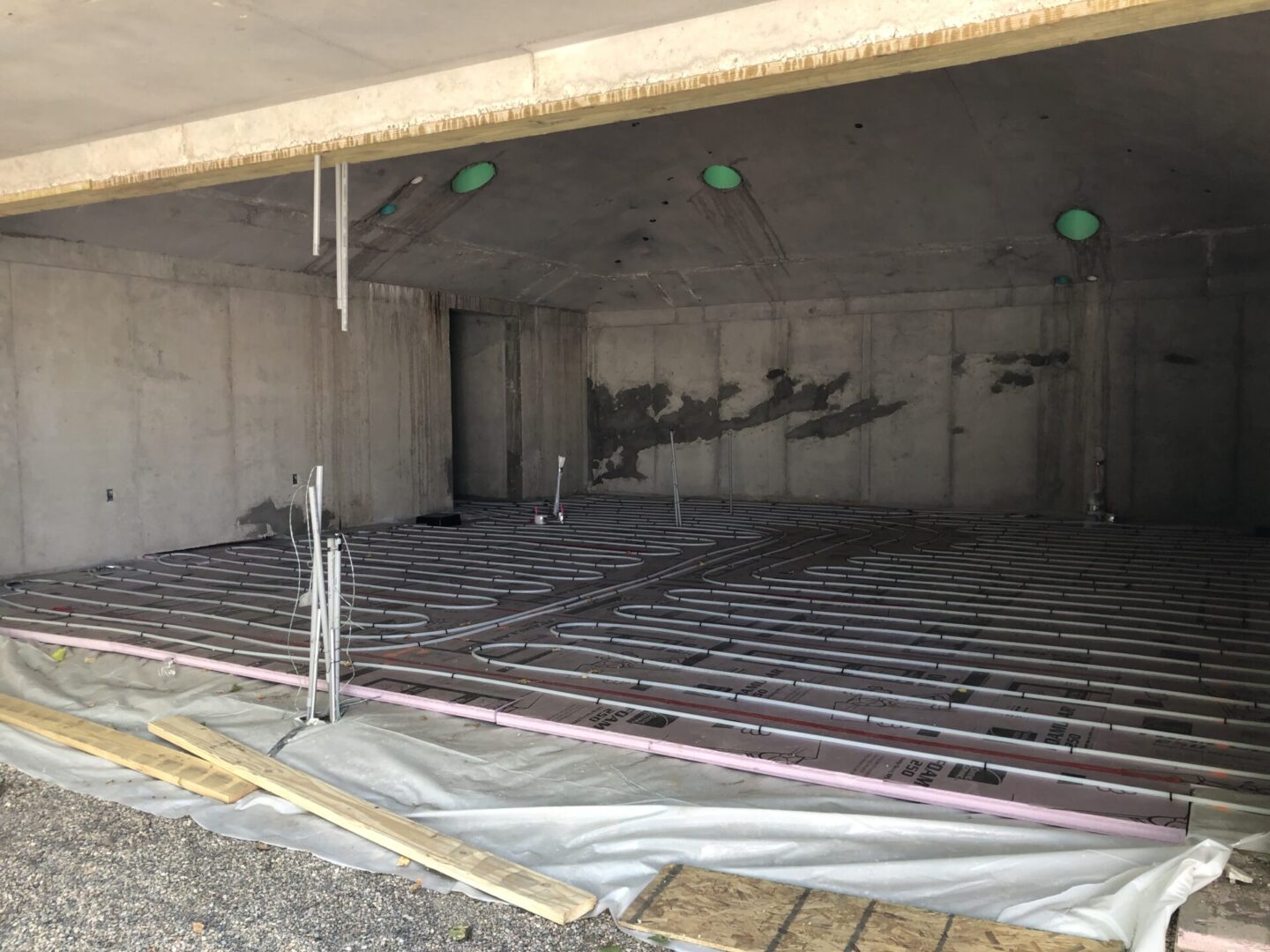 Unfinished concrete room with underfloor heating