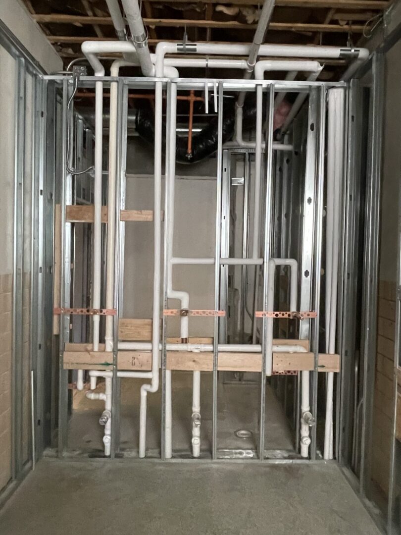 Exposed plumbing and metal studs in construction