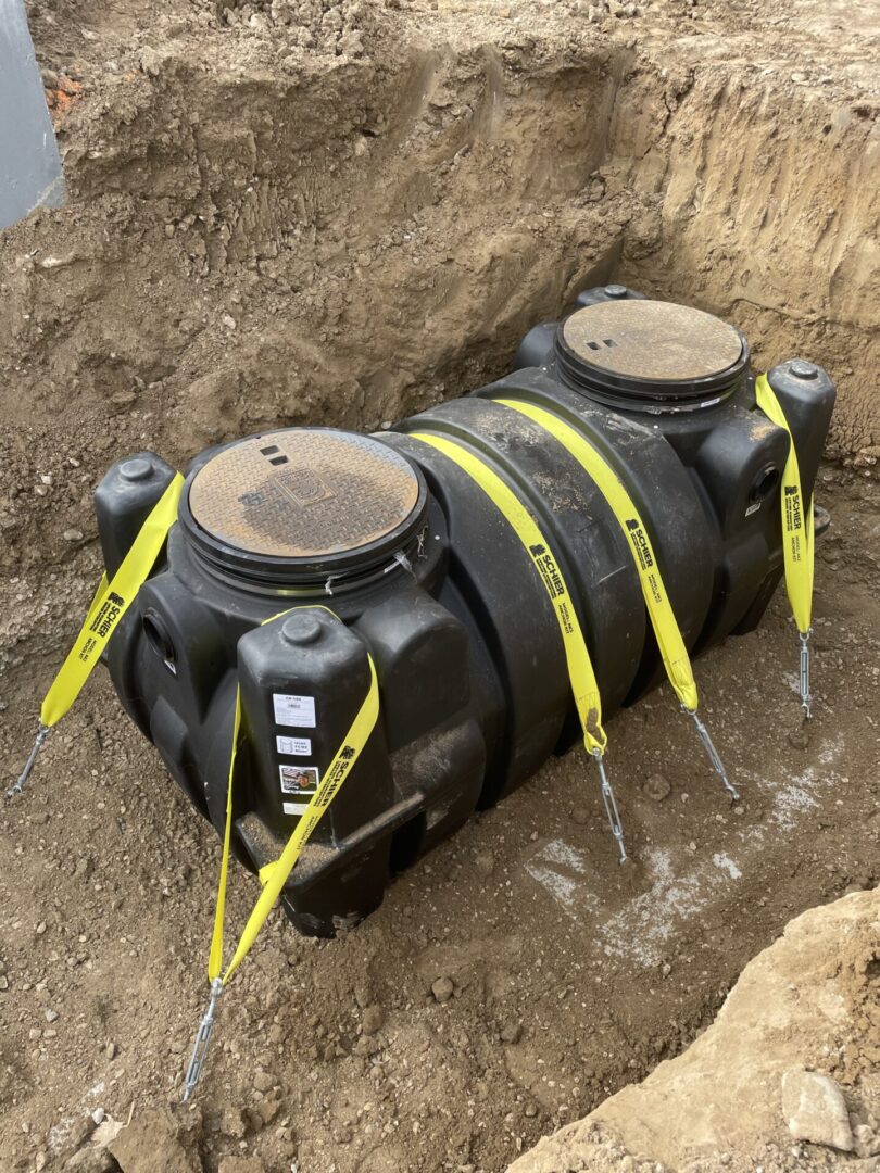 Buried plastic tank anchored with yellow straps